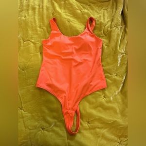 NWOT Popilush Orange shaper bodysuit. Never been worn. Size medium, thong back.